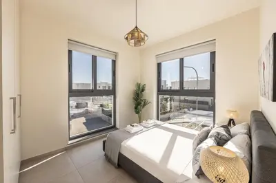 a bedroom with a large bed and large windows at Protaras Hestia Seaside Villa B6 in Protaras