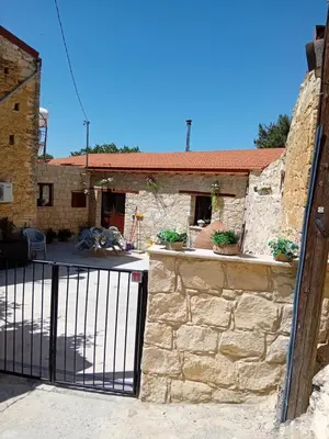 an entrance to a stone building with a gate at TRADITIONAL HOUSE ARSOS in Arsos