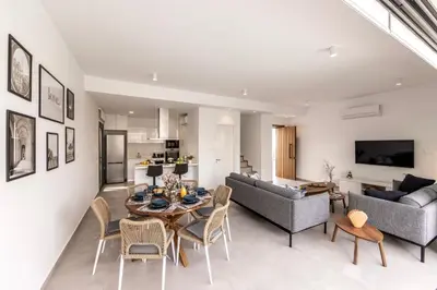a living room with a table and chairs at Protaras By the Bay Villa 32 in Protaras