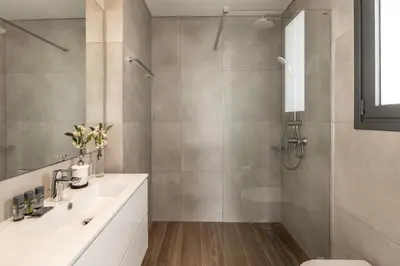 a bathroom with a shower and a toilet and a sink at Protaras By the Bay Villa 32 in Protaras
