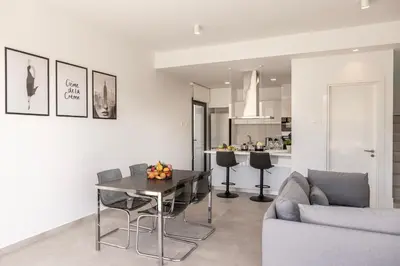 a living room with a table and a couch at Protaras By the Bay Villa 33 in Protaras