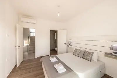 a white bedroom with a bed with a tray on it at Protaras By the Bay Villa 33 in Protaras