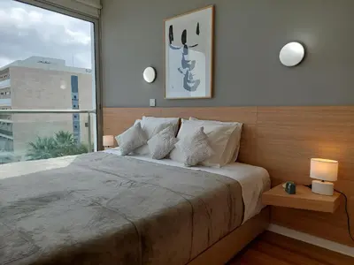a bedroom with a large bed with a large window at Milepost vacations in Paralimni