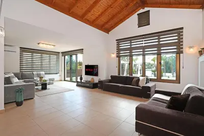 a large living room with couches and a tv at Villa Lara - 3bed Bangalow with Large Pool in Ayia Napa