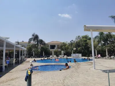 a group of people in a swimming pool at Sunny coast apartment by the sea in Protaras