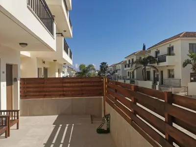 a balcony of a house with a wooden fence at Sunny coast apartment by the sea in Protaras