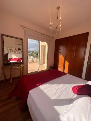 a bedroom with a large bed with a large window at ROSE VILLA - 3 BED POOL in Episkopi Lemesou