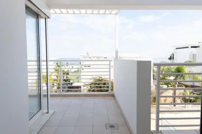 an open balcony with a view of the ocean at Wealthystays Niceday Hill Villa in Protaras