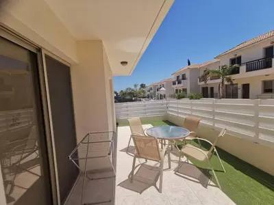 a patio with a table and chairs on a balcony at Beach bliss apartment in Protaras