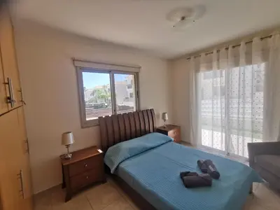 a bedroom with a bed with a teddy bear on it at Beach bliss apartment in Protaras