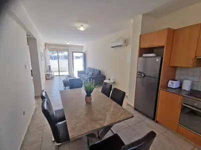 a kitchen and dining room with a table and chairs at Beach bliss apartment in Protaras