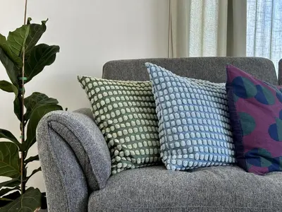 a couch with pillows on it in a living room at Elegant & Central Two Bedroom Flat in Larnaka