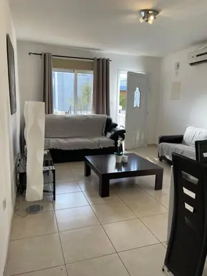 a living room with a couch and a coffee table at Villa Rhea in Ayia Napa