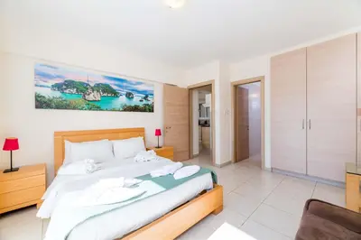 a bedroom with a large bed in a room at Estelle Suite in Ayia Napa