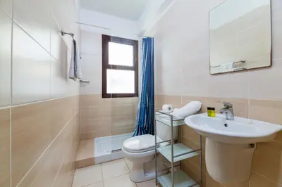 a bathroom with a toilet and a sink at Villa Anna Maria in Ayia Napa