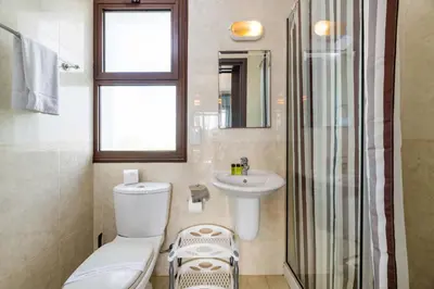 a bathroom with a toilet and a sink and a shower at Villa Anna Maria in Ayia Napa