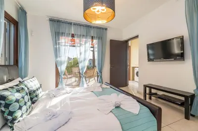 a bedroom with a bed with a bow on it at Villa Anna Maria in Ayia Napa