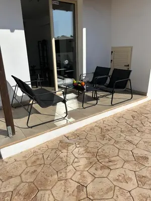 two chairs and a table on a patio at DAFNI VILLA BY PANN in Protaras