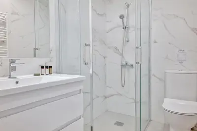 a bathroom with a shower and a sink and a toilet at Phaedrus Living: Luxury Residence Faneromeni in Larnaka