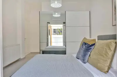 a bedroom with a bed and a mirror at Phaedrus Living: Luxury Residence Faneromeni in Larnaka