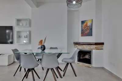 a dining room with a glass table and chairs at Phaedrus Living: Luxury Residence Faneromeni in Larnaka