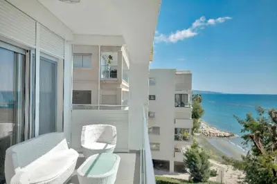 a balcony with chairs and a view of the ocean at Phaedrus Living: Beach Front Flat Kyma in Limassol