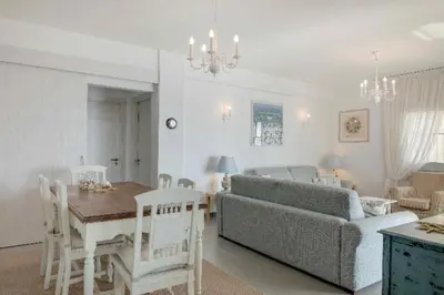 a living room with a couch and a table at Phaedrus Living: Beach Front Flat Kyma in Limassol