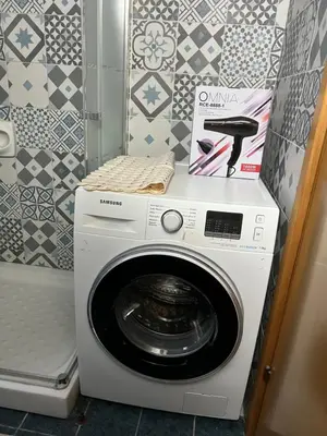 a washing machine with a box on top of it at Makenzie 2 rooms first line beach in Larnaka