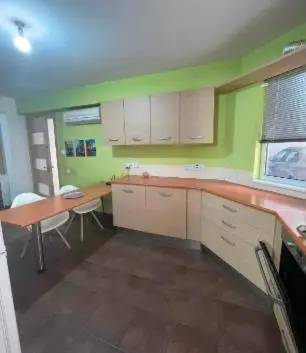 a kitchen with a desk and a table and chairs at Lovely studio in Makedonitissa in Nicosia