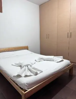 a bed with white sheets and a bow on it at Lovely studio in Makedonitissa in Nicosia