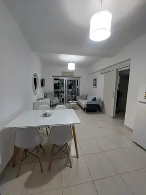 a living room with a white table and chairs at One bedroom city centre in Larnaka