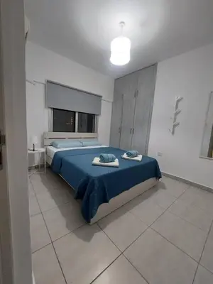 a bedroom with a bed with towels on it at One bedroom city centre in Larnaka