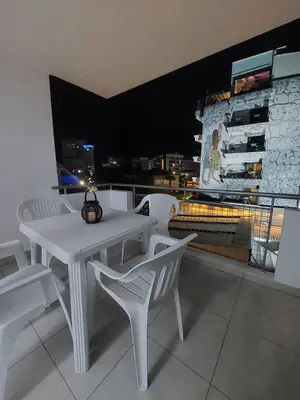 a white table and chairs on a balcony with a view at One bedroom city centre in Larnaka