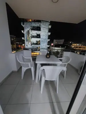 a white table and chairs on a balcony with a view at One bedroom city centre in Larnaka