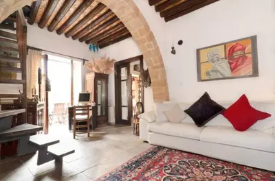 a living room with a white couch and a table at Historical House in the Old City of Nicosia in Nicosia