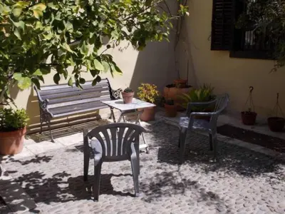 a patio with a bench and a table and chairs at Historical House in the Old City of Nicosia in Nicosia