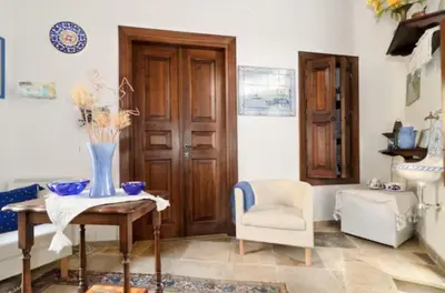 a living room with a table and a chair at Studio in the Old City of Nicosia in Nicosia