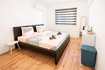 a bedroom with a large bed and a window at COZY Apartment In Kapparis #2 in Paralimni