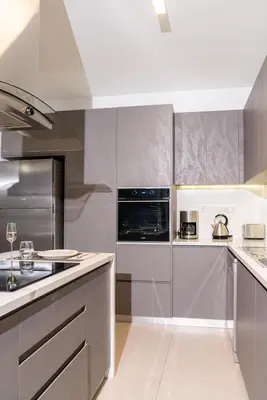 a kitchen with stainless steel appliances and silver cabinets at Venus Apartment in Larnaka