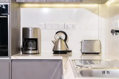 a kitchen with a coffee maker and a tea kettle at Venus Apartment in Larnaka