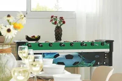 a table with a green oven with a soccer ball on it at Villa Napa Blu in Ayia Napa