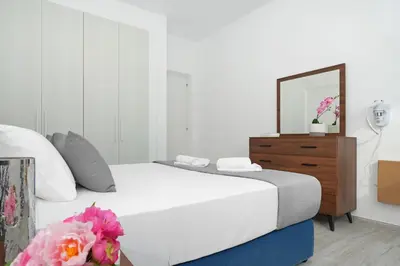 a bedroom with a bed and a dresser with a mirror at Villa Napa Blu in Ayia Napa