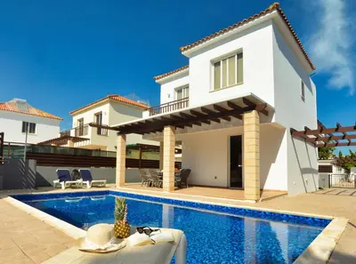 a villa with a swimming pool and a house at Villa Argyro in Ayia Napa