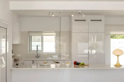 a white kitchen with white cabinets and a sink at SunnyVillas-3BR New Modern Villa-Private Pool-BLG in Paralimni