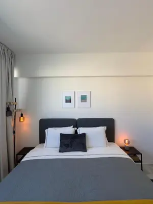 a bedroom with a large bed with two pillows at MARTIN Nicosia City Suites in Nicosia
