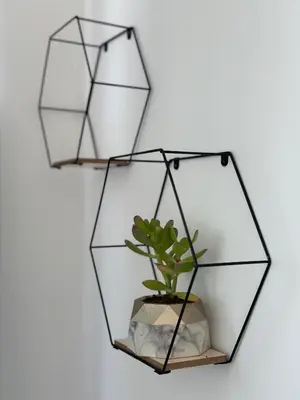 a black hexagonal mirror with a plant at MARTIN Nicosia City Suites in Nicosia