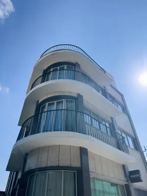 a tall building with balconies on top of it at MARTIN Nicosia City Suites in Nicosia