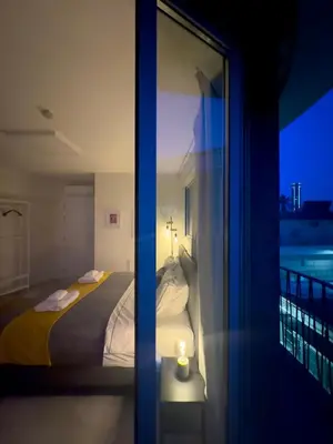 a bedroom with a bed and a view of a balcony at MARTIN Nicosia City Suites in Nicosia