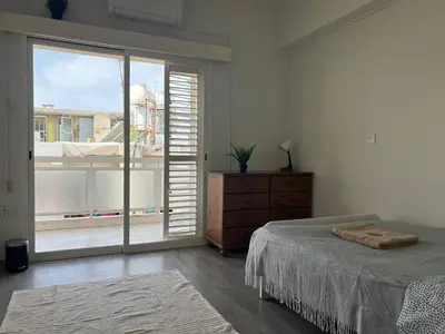 a bedroom with a bed and a large window at Quiet place in Limassol
