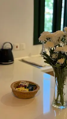 a vase with flowers and a basket on a counter at Pirella House in Limassol